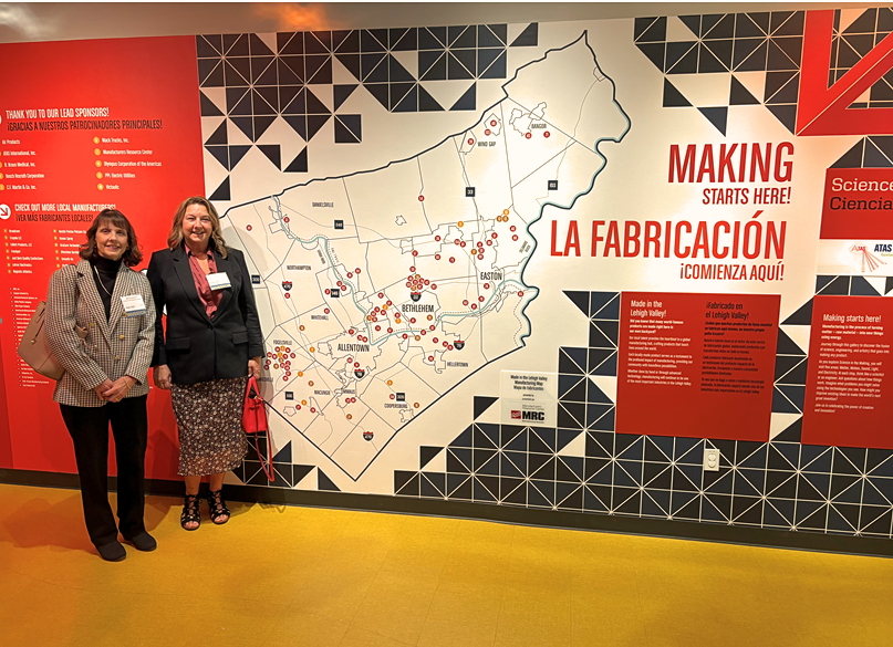 Diane Lewis and Wendy Beltzner in front of DaVinci LV Manufacturing Map Exhibit